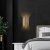 Vegglampe i gullfinish - Munnspill